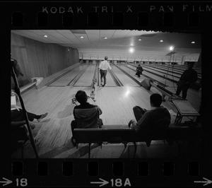 Mayor Kevin White bowling while Boston Police bowling team members watch in the foreground at Lucky Strike Alley