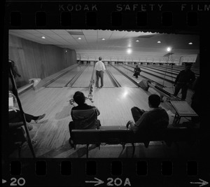 Mayor Kevin White bowling while Boston Police bowling team members watch in the foreground at Lucky Strike Alley