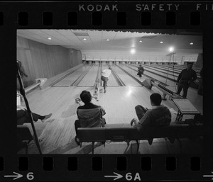 Mayor Kevin White bowling with Boston Police bowling team watching in the foreground at Lucky Strike Alley