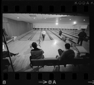 Mayor Kevin White bowling with Boston Police bowling team watching in the foreground at Lucky Strike Alley