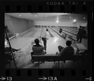 Mayor Kevin White bowling with Boston Police bowling team watching in the foreground at Lucky Strike Alley