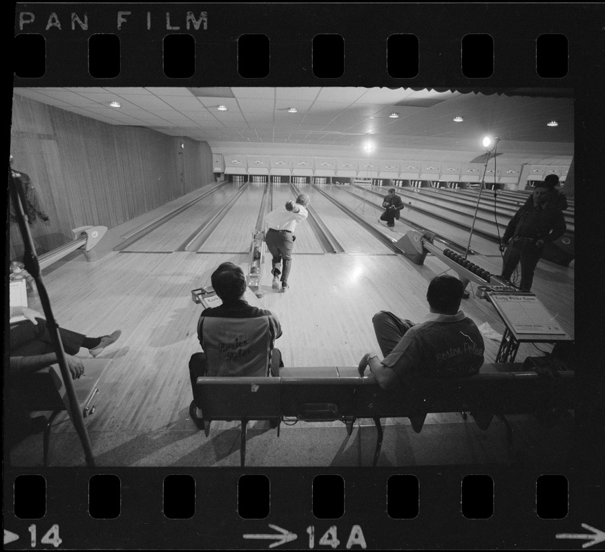 Mayor Kevin White bowling with Boston Police bowling team watching in the foreground at Lucky Strike Alley