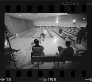 Mayor Kevin White bowling with Boston Police bowling team watching in the foreground at Lucky Strike Alley