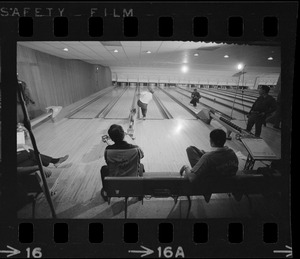 Mayor Kevin White bowling with Boston Police bowling team watching in the foreground at Lucky Strike Alley