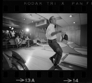 Mayor Kevin White bowling with Boston Police bowling team watching in the back at Lucky Strike Alley