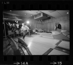 Mayor Kevin White bowling with Boston Police bowling team watching in the back at Lucky Strike Alley