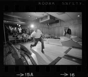 Mayor Kevin White bowling with Boston Police bowling team watching in the back at Lucky Strike Alley