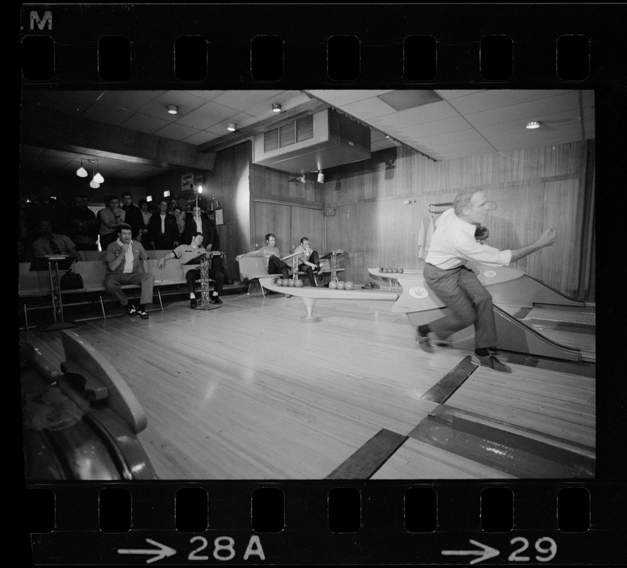 Mayor Kevin White bowling with Boston Police bowling team watching in the back at Lucky Strike Alley