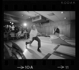 Mayor Kevin White bowling with Boston Police bowling team watching in the back at Lucky Strike Alley