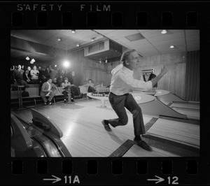 Mayor Kevin White bowling with Boston Police bowling team watching in the back at Lucky Strike Alley