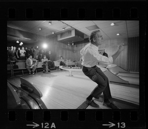 Mayor Kevin White bowling with Boston Police bowling team watching in the back at Lucky Strike Alley