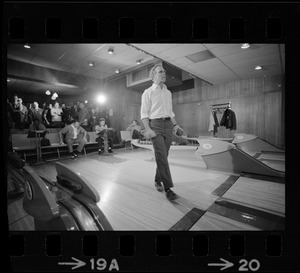 Mayor Kevin White bowling with Boston Police bowling team watching in the back at Lucky Strike Alley