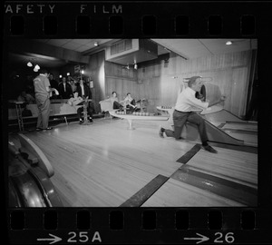 Mayor Kevin White bowling with Boston Police bowling team watching in the back at Lucky Strike Alley