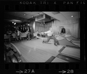 Mayor Kevin White bowling with Boston Police bowling team watching in the back at Lucky Strike Alley