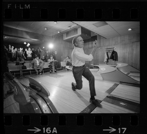 Mayor Kevin White bowling with Boston Police bowling team watching in the back at Lucky Strike Alley