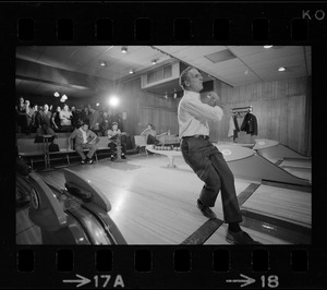 Mayor Kevin White bowling with Boston Police bowling team watching in the back at Lucky Strike Alley