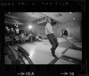 Mayor Kevin White bowling with Boston Police bowling team watching in the back at Lucky Strike Alley