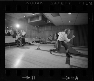 Mayor Kevin White bowling with Boston Police bowling team watching in the back at Lucky Strike Alley