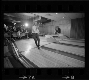 Mayor Kevin White bowling with Boston Police bowling team watching in the back at Lucky Strike Alley