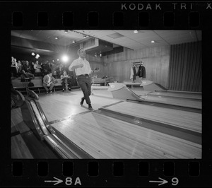 Mayor Kevin White bowling with Boston Police bowling team watching in the back at Lucky Strike Alley