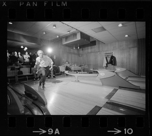 Mayor Kevin White bowling with Boston Police bowling team watching in the back at Lucky Strike Alley