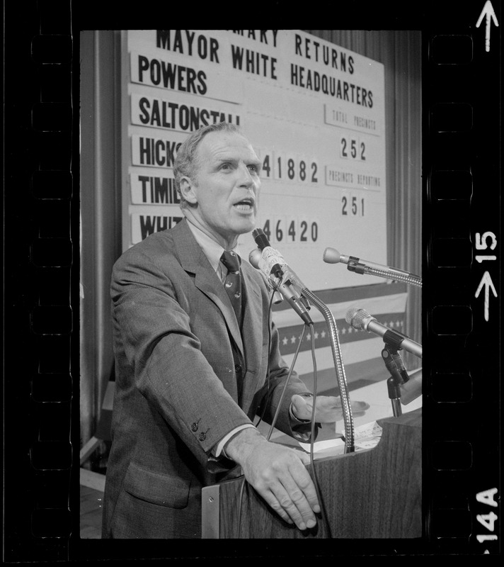 Boston Mayor Kevin White speaking to campaign workers at his headquarters, board tracking primary returns in background