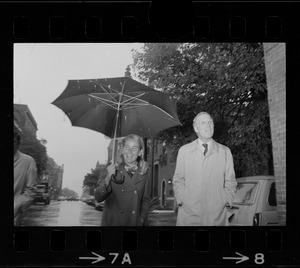 Boston Mayor Kevin White and Kathryn White walking through rain to vote in the primary