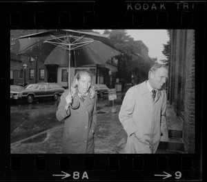 Boston Mayor Kevin White and Kathryn White walking through rain to vote in the primary