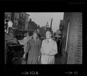 Boston Mayor Kevin White and Kathryn White walking through rain to vote in the primary