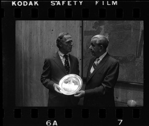 Boston Mayor Kevin White receiving silver plate from F. Frederick Moynihan, Chairman of the Board of A. Stowell Co. Inc.