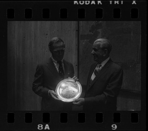 Boston Mayor Kevin White receiving silver plate from F. Frederick Moynihan, Chairman of the Board of A. Stowell Co. Inc.