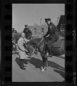Boston Mayor Kevin White talking to mounted policeman before the St. Patrick's Day parade