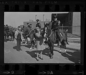 Kathryn White stroking police horse's nose with mounted policeman before the St. Patrick's Day parade