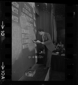 Man filling in election returns on tracking board at Kevin White's election night party at Bradford Hotel during primary race for governor of Massachusetts