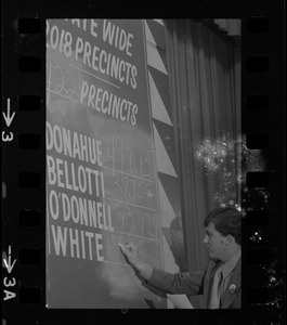 Man filling in election returns on tracking board at Kevin White's election night party at Bradford Hotel during primary race for governor of Massachusetts
