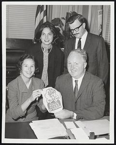 Mayor Collins buys the first "litter bag" in plan to Cleanup Boston from, left to right, Mrs. Louis Kane, president, Boston League of Women Voters, Mrs. Wilfred Calmas, League Finance Chairman, and John Abbott, administrator of Morgan Memorial's New England Rehabilitation-for Work-Center.