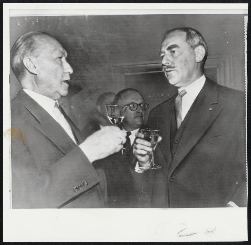 Toast to German Accord-- West German Chancellor Adenauer (left) and Secretary Acheson clink glasses of reception in Bonn to Big Three officials to present for signing of peace contract today.