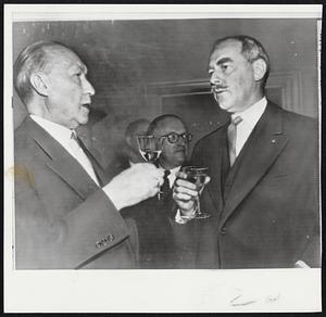 Toast to German Accord-- West German Chancellor Adenauer (left) and Secretary Acheson clink glasses of reception in Bonn to Big Three officials to present for signing of peace contract today.
