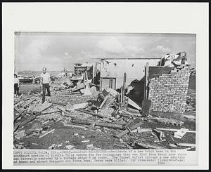 Salvage Belongings--Residents of a new brick home in the southeast section of Wichita Falls remove the few belongings they can find from their home which was literally exploded by a tornado about 3 pm today. The funnel rifled through a new addition of homes and struck Sheppard Air Force Base. Seven were killed.