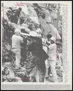 The body of an unidentified woman is removed 7/31 from the ruins of a building destroyed by earth tremors 7/29. A new, light earthquake shook residential districts of Caracas 7/31, but no deaths or major damage were reported.