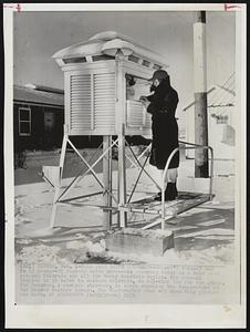 Cold Wave Grips Colorado -- Denver's coldest day in 15 years -- 25 degrees below zero -- was recorded today as a cold wave gripped Colorado and all the Rocky Mountain region. The mercury dropped to 59 below in Western Colorado, an all-time low for the state. Ted Brondun, a weather observer, is shown checking the temperature at the Denver weather bureau. The thermometer read -22 when this picture was made.