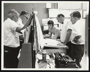 A Very Busy Man yesterday was Dr. Oscar Tenenbaum, chief meteorologist of the Boston Weather Bureau, shown in top photo charting course of Hurricane Gerda. Below, other bureau personnel, including Charles Pierce, supervising forecaster, second left, at work.