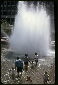 People swimming in the Boston City Hall plaza fountain