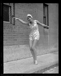 A woman in a cap and bathing suit