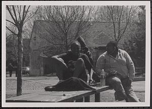 Three young people sitting on table at Danehy Park