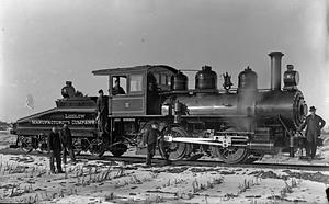 Locomotive No. 5 with men standing around the engine