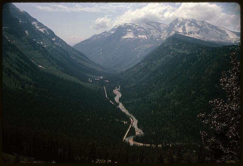 View from above of river running through mountain valley