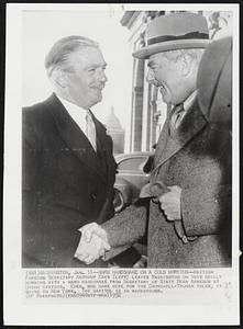 Warm Handshake on a Cold Morning--British Foreign Secretary Anthony Eden (left) leaves Washington on this chilly morning with a warm handshake from Secretary of State Dean Acheson at Union Station. Eden, who came here for the Churchill-Truman talks, is going to New York. The capitol is in the background.