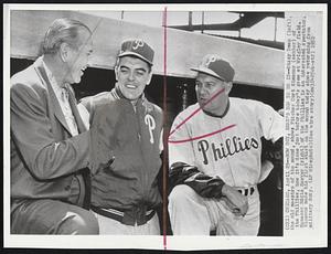 Now boy, Here's how to do it--Dizzy Dean (left) the old maestro of the mound, shows Pitcher Curt Simmons (center) of the Phillies, how it's done just before today's game at Wrigley field. Manager Eddie Sawyer (right) of the Phillies is an interested spectator. Simmons made his first start on the mound today since returning from military duty.