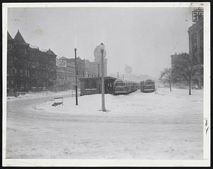 Normally Busy Kenmore Sq. saw few cars in rush hour today as big storm struck Boston. Only buses can be seen in the area. Many motorists left cars at home to avoid a repeat of Friday's traffic debacle.
